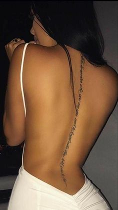 the back of a woman's body with tattoos on her upper and lower back