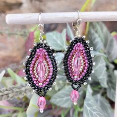 Embrace the dazzling beauty and vibrant energy of our Swarovski Crystal Beadwork Drop Earrings, available in four enchanting styles: "Shades of the Sea," "Coral Burst," "Purple Haze," and "Tapestry." Each pair showcases exquisite Swarovski Crystal barrel beads paired with meticulously selected seed beads, creating a harmonious blend of color and sparkle.  Wrap yourself in the romantic allure of our "Tapestry" earrings. Featuring Rose Swarovski Crystal barrel beads, paired with black, rose, and s Handmade Multicolor Crystal Elegant Earrings, Handmade Multicolor Crystal Earrings, Handmade Multicolor Elegant Crystal Earrings, Handmade Elegant Multicolor Crystal Earrings, Elegant Multicolor Handmade Crystal Earrings, Elegant Multicolor Beaded Crystal Earrings, Handmade Teardrop Beaded Earrings For Parties, Festive Beaded Teardrop Earrings, Festive Teardrop Beaded Earrings