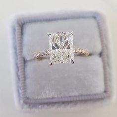 an engagement ring with a cushion cut diamond