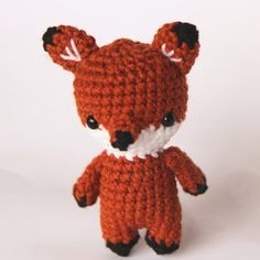 a crocheted stuffed animal that looks like a little fox with big ears and tail