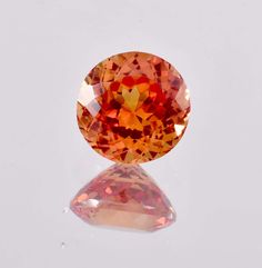 an orange diamond is shown on a white surface