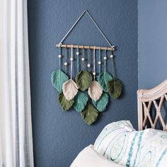 a bedroom with blue walls and green leaves hanging on the wall