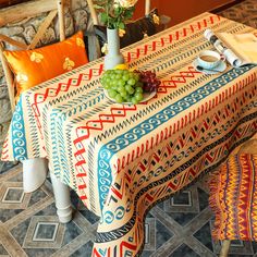 a dining room table covered in colorful cloths