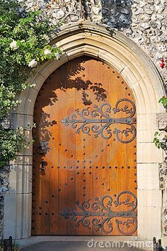 an old church door with vines growing over it