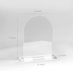 a clear acrylic arch stands on a white background with measurements for each section