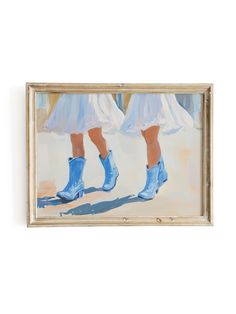 two women in blue boots are walking down the street