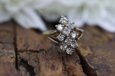 Stunning Ring. Vintage 14k Yellow Gold. Ring is designed with a Solitaire style and a cluster of diamonds. Cluster is formed in marquise pattern. Sparkle nicely.  Condition: Ring shows tiny scratches. Was not polished. Details: 14k Gold 2.5 Total Grams 2.25mm 10 total diamonds. 0.40ctw 14k Gold Cluster Diamond Ring With Prong Setting, 14k Gold Cluster Diamond Ring In Diamond White, 14k Gold Cluster Diamond Ring With Vvs Clarity, 14k Gold Cluster Diamond Cut Wedding Rings, Cluster Diamond Ring With Rose Cut For Anniversary, Cluster Rose Cut Diamond Ring For Anniversary, Moissanite Cluster Ring With Single Cut Diamonds For Anniversary, Fine Jewelry Diamond Ring With Single Cut Cluster, Cluster Diamond Ring For Anniversary