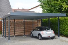 a car is parked under a metal carport