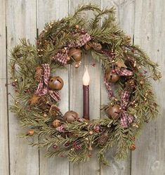 a christmas wreath hanging on the side of a wooden fence