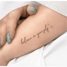 a woman's arm with the words believe in yourself tattooed on her left side