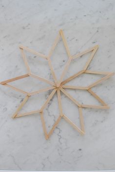 a wooden snowflake sitting on top of a white marble counter