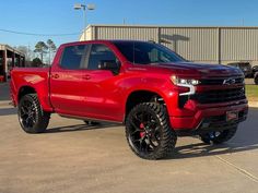 a red truck parked in a parking lot