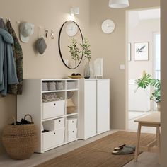 a white cabinet with baskets and shoes on the floor