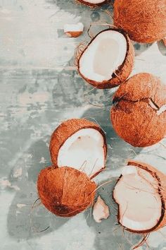 three coconuts are sitting on the ground next to each other