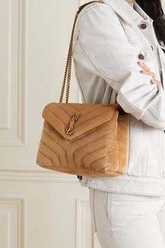 SAINT LAURENT's 'Loulou' bag is inspired by Loulou de la Falaise, the founder's friend and muse who embodied the Rive Gauche  haute bohémienne  of the '70s. Made from velvety-soft suede, this brown version features the signature chevron quilted finish and house's gilded logo plaque at the front. Ysl Loulou Bag, Sac Yves Saint Laurent, Ysl Purse, Ysl Handbags, Suede Outfit, Latest Bags, Yves Saint Laurent Bags, Small Quilts, Brown Bags