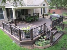 a deck with chairs and potted plants on it