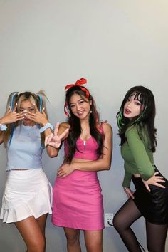 three young women posing for the camera