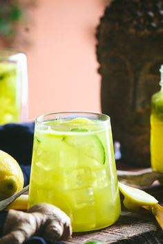 a glass filled with lemonade sitting on top of a table