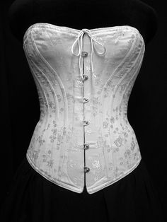 "Our c. 1880 Alice Victorian corset is designed to be worn with the long, close-fitting cuirasse bodices of the 1880s. Ideal shaping when worn with your Victorian costumes and Victorian clothing or for a bridal corset. Either worn alone as part of your wedding dress or as an undergarment this style is generously boned giving the wearing an extreme nipped in waist. Also a great addition to any Cosplay costume or Steampunk ensemble. The front panels allow a generous fullness in the bust and hips w Victorian Underbust Wedding Bodice, Wedding Underbust Corset With Historical Design, Victorian Overbust Wedding Corset, Historical Underbust Corset Dress For Wedding, Wedding Underbust Corset Dress With Historical Design, Victorian Overbust Wedding Bodice, Fitted Gothic Bodice For Wedding, Gothic Fitted Bodice For Wedding, Victorian Corset With Historical Design For Wedding