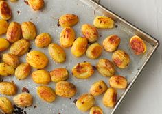 peeled and uncooked nuts on a baking sheet