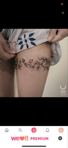 a woman is showing off her thigh with tattoos on the side and flowers growing out of it