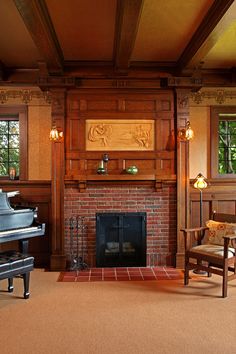 a living room filled with furniture and a piano in front of a brick fire place