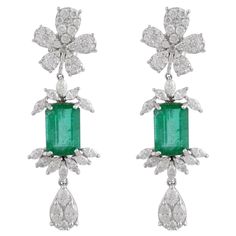 These exquisite earrings are handcrafted in 14-karat gold. It is set in 3.65 carats emerald and 6.15 carats of sparkling diamonds. Available in white, rose and yellow gold. FOLLOW MEGHNA JEWELS storefront to view the latest collection & exclusive pieces. Meghna Jewels is proudly rated as a Top Seller on 1stDibs with 5 star customer reviews. All items manufactured by us are handmade and can be customized or redesigned. Certificate available upon request. Composition Total Weight 11.34 grams 14k W Jeweled Picture, Diamond Dangle Earrings, Zambian Emerald, Earrings Diamond, Emerald Earrings, Emerald Stone, Emerald Gemstone, Van Cleef, Floral Earrings