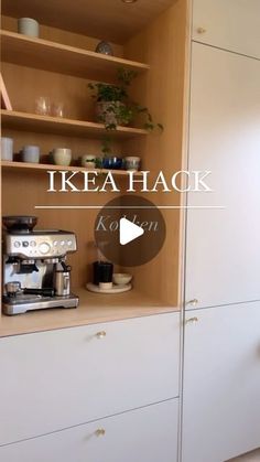 a coffee maker sitting on top of a wooden shelf next to a white cupboard filled with dishes