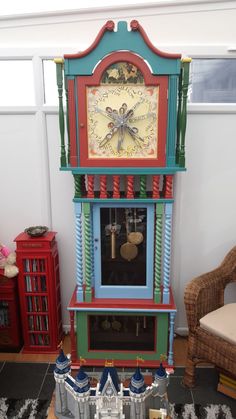 a brightly colored grandfather clock on display in a living room