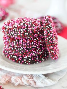 a cake with sprinkles on it sitting on top of a white plate