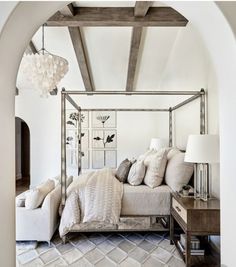 a bedroom with a canopy bed and white furniture