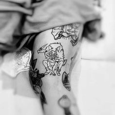 black and white photo of a person with tattoos on their legs