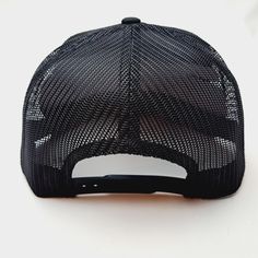 a black and white trucker hat sitting on top of a table