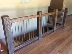 two wooden baby gates sitting on top of a hard wood floor