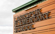 a wooden sign that says larkkspurr elementary school