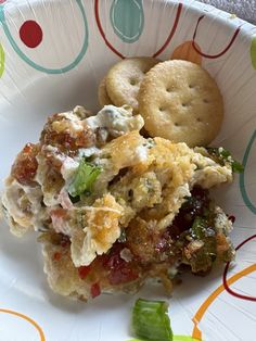 a white plate topped with food and crackers