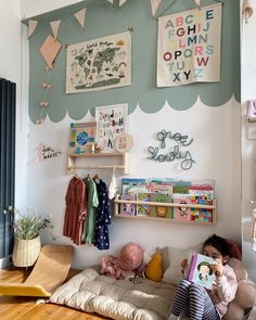 a child's room with bookshelves, toys and posters on the wall