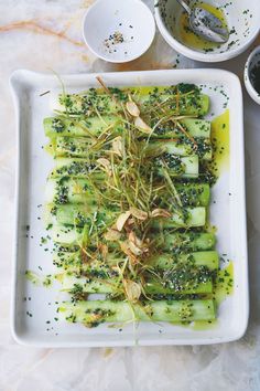 a white plate topped with broccoli and sprouts on top of a table