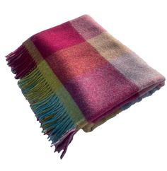 a multicolored plaid blanket on a white background