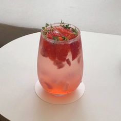 a drink with strawberries in it sitting on a table