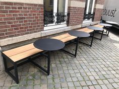 three tables sitting on the side of a building