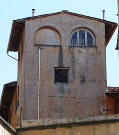 an old building with two windows and a balcony