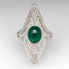 This exquisite ring features a pierced design, centered with an oval, emerald cabochon, weighing 1.75 carats, in a full bezel setting, accented with milgrain details. The top of the ring is accented with one hundred six (106) bead set, round single cut diamonds. The ring measures 31.9mm at the top, rises 8.0mm above the finger, tapering to 1.5mm wide and 0.8mm thick at the base of the shank. This ring is currently a size 5.75. The emerald has surface reaching natural inclusions. Luxury Oval Emerald Birthstone Ring, Fine Jewelry Emerald Oval Cabochon Ring, Fine Jewelry Emerald Ring With Oval Cabochon, Emerald Oval Cabochon Ring In Fine Jewelry Style, Luxury Emerald Ring With Oval Cabochon And 17 Jewels, Luxury Oval Cabochon Emerald Ring With 17 Jewels, Classic Diamond Ring With Cabochon Cut, Classic Diamond Cabochon Ring, Elegant Emerald Ring With Cabochon Cut