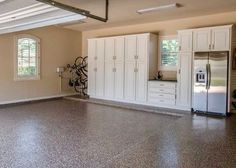 an empty room with white cabinets and a bike on the wall