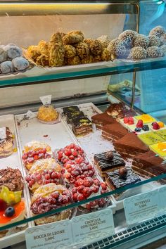 a display case filled with lots of different types of desserts