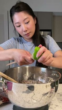 a woman is mixing ingredients in a large bowl