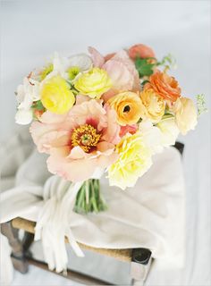 a bouquet of flowers sitting on top of a chair