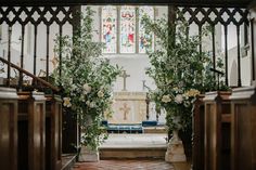 the altar is decorated with flowers and greenery