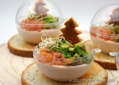 three small bowls filled with food on top of slices of bread