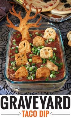 a close up of food in a pan on a table with text overlay that reads graveyard taco dip